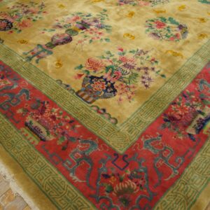 High-pile rug featuring a gold field with colorful floral vases and a complex red, teal, and green border.