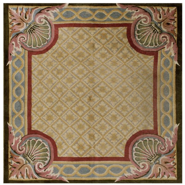 Square rug featuring a tan diamond pattern field bordered by maroon, blue, pink, and olive motifs.