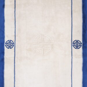 A plush white rectangular rug featuring a wide blue border and dark blue traditional Shou symbols along the edge.