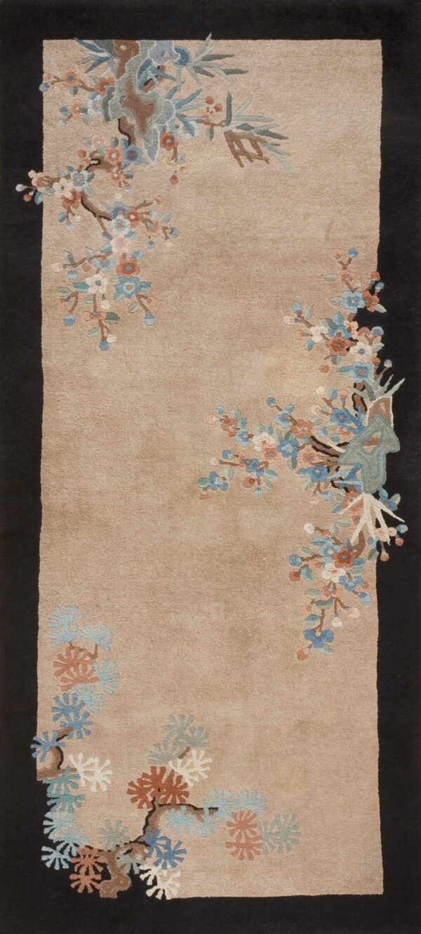 Beige rug featuring sprawling blue and pink blossoms, framed by wide, solid dark brown side borders.