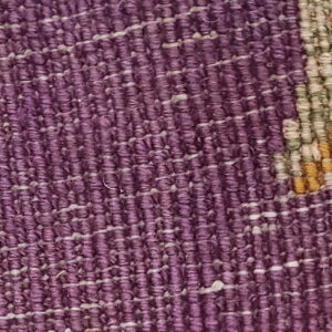 High-pile purple, yellow, and green patterning meets a tight purple and white woven texture edge.
