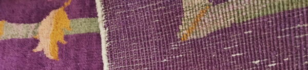 High-pile purple, yellow, and green patterning meets a tight purple and white woven texture edge.