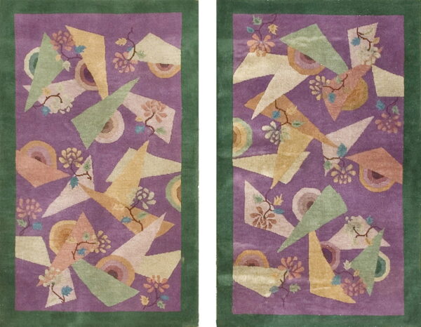 A pair of purple and green bordered rugs with multicolored geometric and abstract floral patterns.