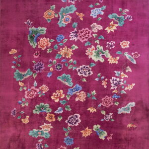 Vibrant purple rug featuring an all-over design of large, colorful floral bouquets and vines.