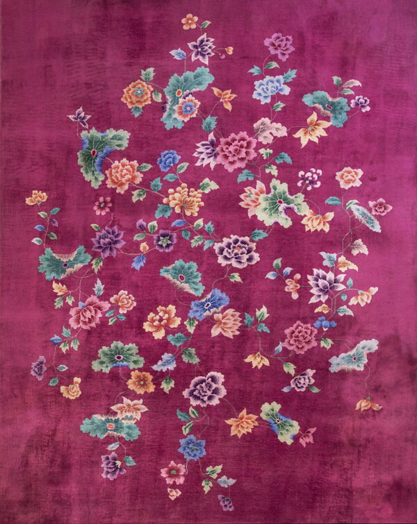 Vibrant purple rug featuring an all-over design of large, colorful floral bouquets and vines.