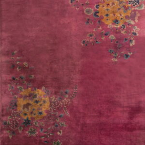 Plush magenta rug displaying two asymmetrical yellow floral clusters with blue and green accents.