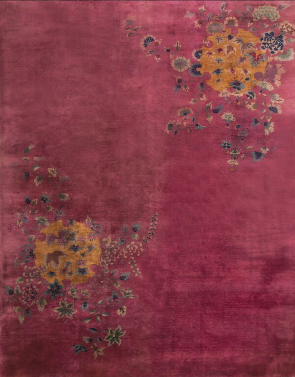 Plush magenta rug displaying two asymmetrical yellow floral clusters with blue and green accents.