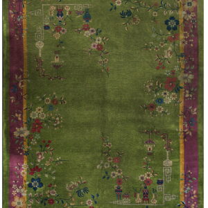 A chartreuse green rug features a deep magenta border and an elaborate vine and floral motif pattern.