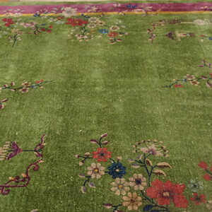 Lime green high-pile rug with elaborate magenta and yellow borders and multicolored floral motifs.