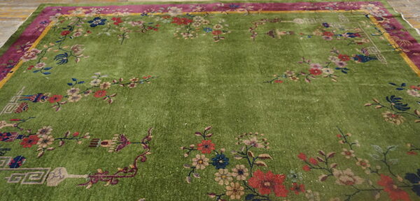 Lime green high-pile rug with elaborate magenta and yellow borders and multicolored floral motifs.