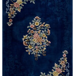 Plush, dark blue rug with a central multicolored floral medallion and subtle tone-on-tone carving.