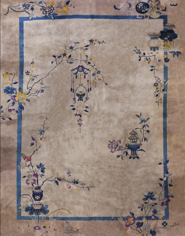 Taupe rug with a low pile, featuring a blue border and detailed floral vines, vases, and hanging lanterns.