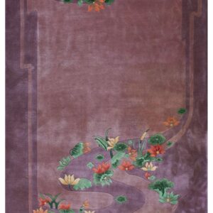 Purple rug with sculpted orange and yellow floral designs outlining a winding mauve border.