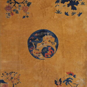 Ochre field rug featuring a navy blue central medallion surrounded by floral and landscape patterns.