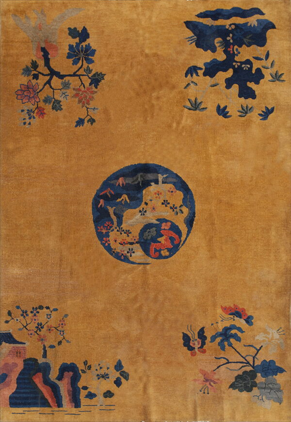 Ochre field rug featuring a navy blue central medallion surrounded by floral and landscape patterns.