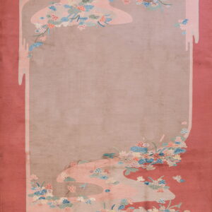 Rosy-red rug with a central beige field framed by stylized pink, blue, and sage floral motifs.