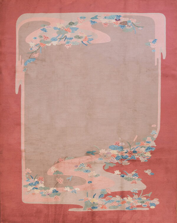Rosy-red rug with a central beige field framed by stylized pink, blue, and sage floral motifs.