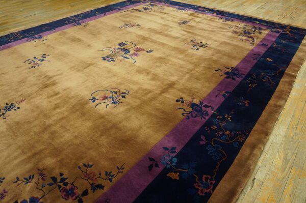 High-sheen tan rug with scattered florals and thick purple and navy botanical borders on hardwood.
