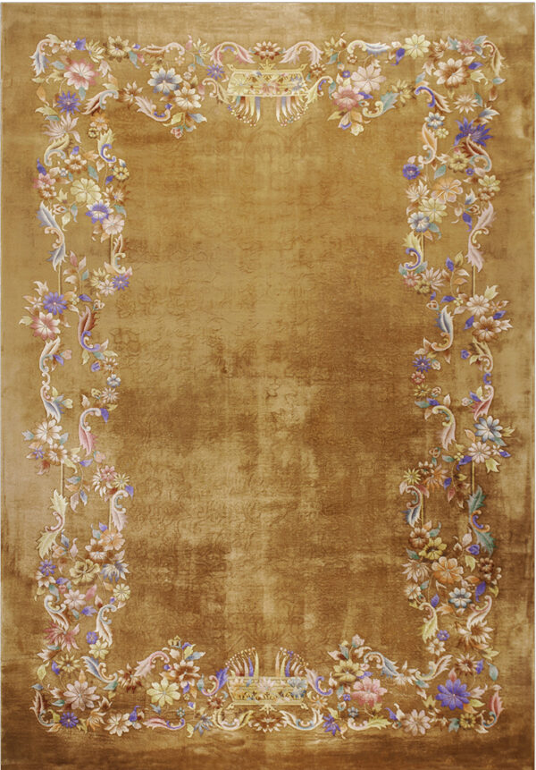 Amber rug with a distressed gold center and an ornate multicolored floral and vine border.