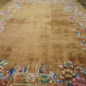 Shimmering tan rug featuring a spacious field and a colorful pastel floral border on distressed wood planks.