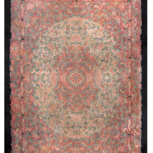 Muted pink and sage floral rug featuring a dense pattern and central medallion on a dark background.