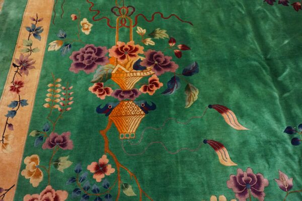 Vibrant green rug featuring a floral basket design with purple and pink flowers and a tan side border.