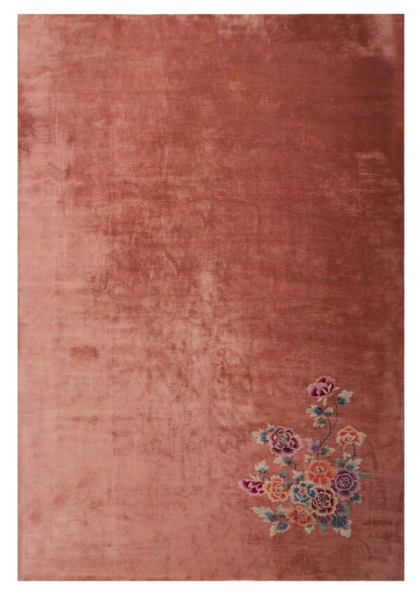 A plush dusty rose rug with directional shading and a bright floral bouquet in the lower right.