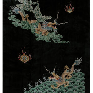 Detailed black rug featuring two golden dragons flying above green clouds and ocean waves.