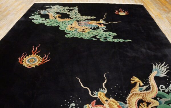 Plush black rug with yellow dragons, pale green clouds, and fiery accents on light wooden floor.