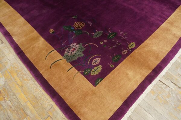 Purple high-pile rug with a gold border and colorful botanical motifs on distressed wood floors.