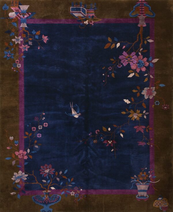Deep blue high-pile rug with a detailed floral and bird pattern and a wide brown outer border.