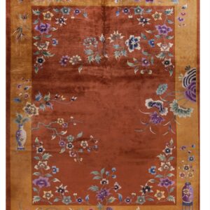 Terracotta rug with a golden border and a repeating pattern of multicolor floral vines and vases.