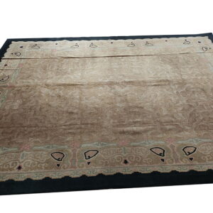 Tan rug featuring a subtle tone-on-tone floral pattern, framed by a dark border with stylized black motifs.
