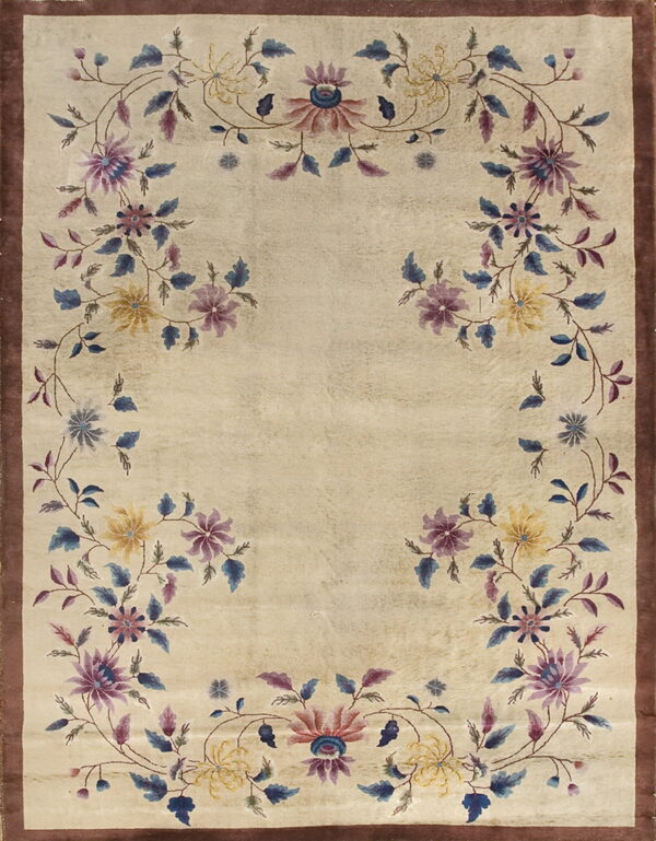 Beige rug with a brown border and an open vine pattern featuring purple, blue, and yellow stylized flowers.
