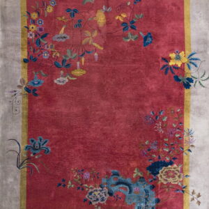 Deep red rug with stylized multi-colored floral vines, bordered by yellow and a wide pale gray edge.