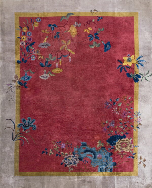 Deep red rug with stylized multi-colored floral vines, bordered by yellow and a wide pale gray edge.
