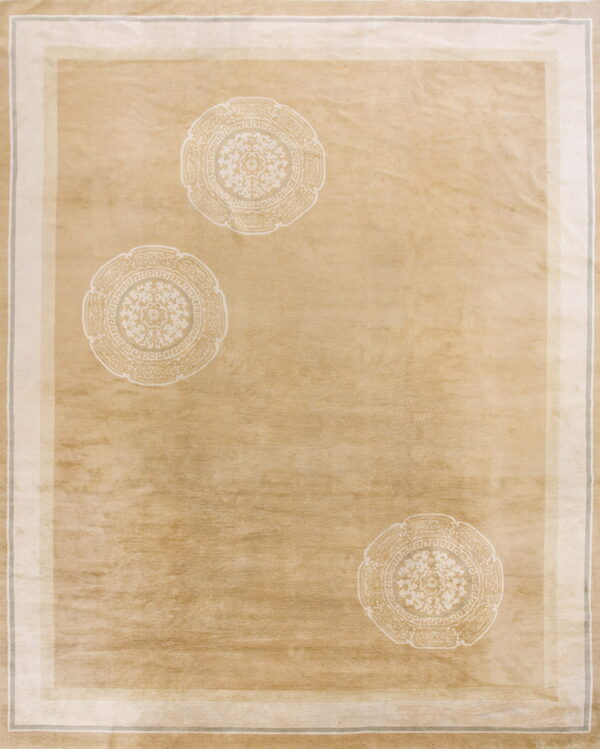 Tan low-pile rug featuring three subtle off-white circular medallions and a multi-layered light-colored border.