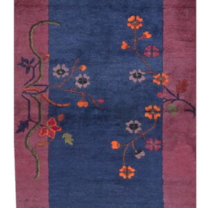 Plush runner rug with a deep blue center framed by mauve stripes and colorful blooming vines.