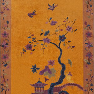 High-pile orange rug depicting a flowering tree, pagoda, and birds within a tan floral border.