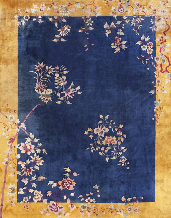 Blue field rug with decorative floral vine patterns and a highly contrasted wide gold border.