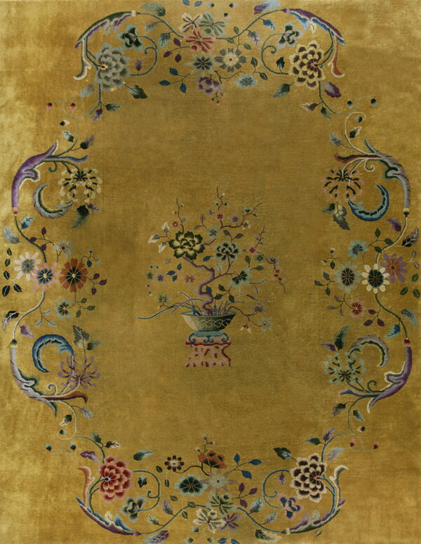 Plush chartreuse rug with a dense multicolored floral arrangement framing a central potted tree motif.