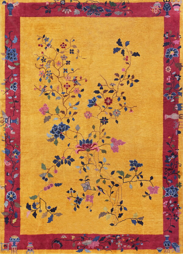 Yellow rug featuring a spreading vine pattern with blue flowers and a detailed red border with vase motifs.