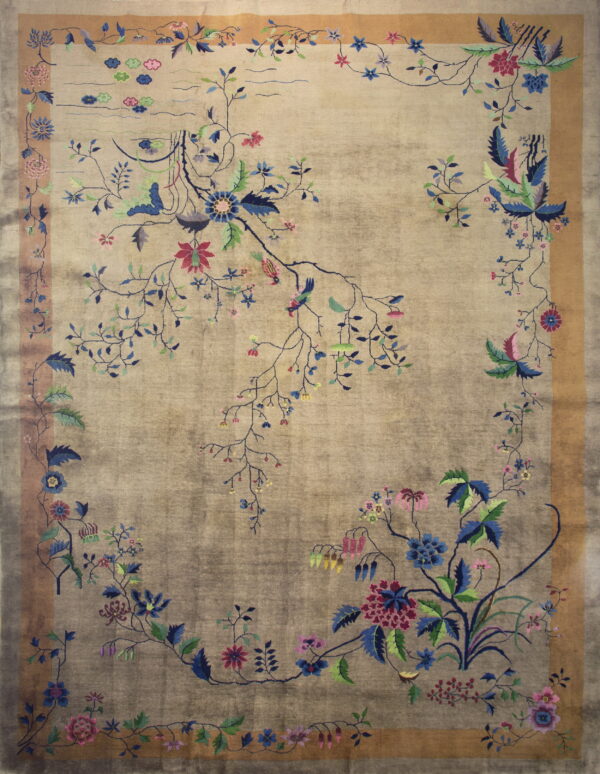 A muted beige and gray rug with high sheen displays a colorful, intricate floral and bird pattern.