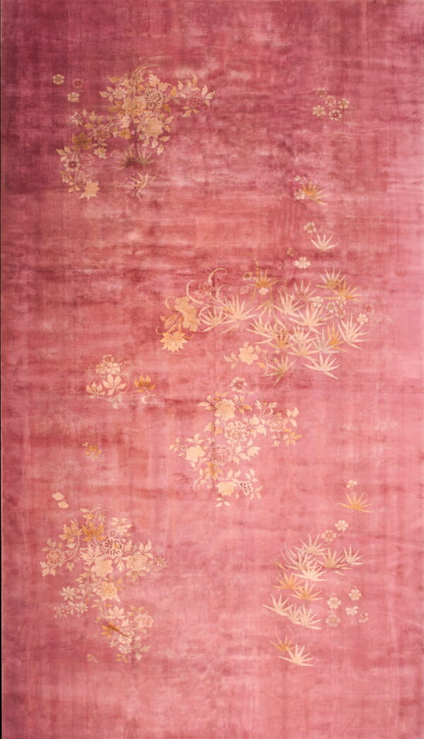 A long, shaded pink rug featuring scattered clusters of pale beige botanical motifs.