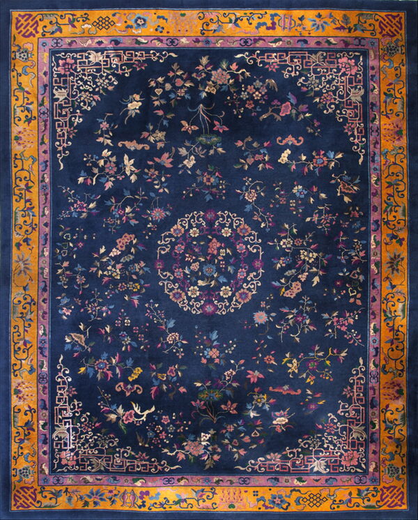 Navy blue rug featuring scattered colorful floral motifs and a detailed gold and purple border.