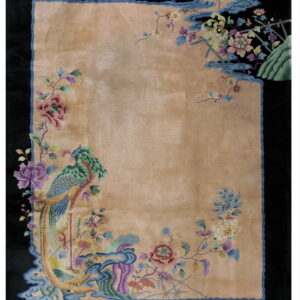 Tan rug with a black border, featuring colorful floral motifs and a large blue and green bird design.