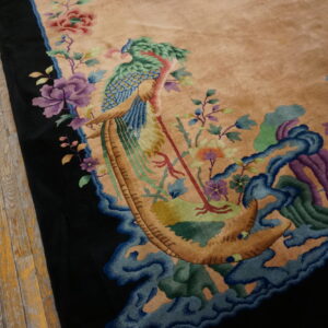 Plush tan rug featuring a carved peacock and flower pattern in blue, purple, and green, beside worn wood planks.