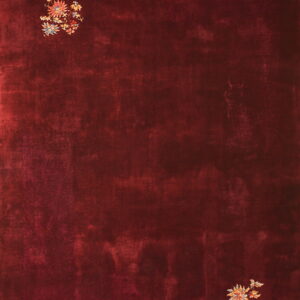 Deep red rug with a mottled field texture and scattered multicolored floral motifs.
