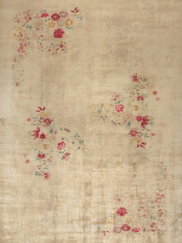 A distressed beige rug features scattered faded pink and blue floral bouquets and a subtle sheen.