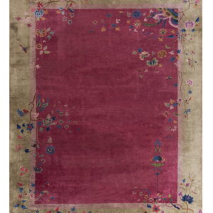 Plush magenta rug with a wide khaki border patterned with stylized vines and colorful flowers.